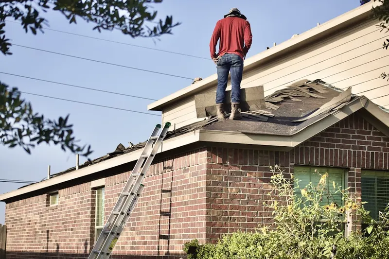 Professional roofer working on a residential roof in Atlantis